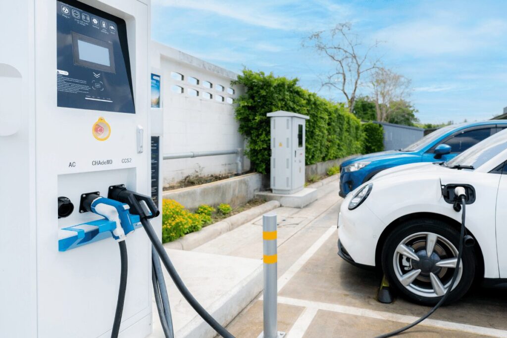 Drive Green - Electric Vehicle charging at charging station. 