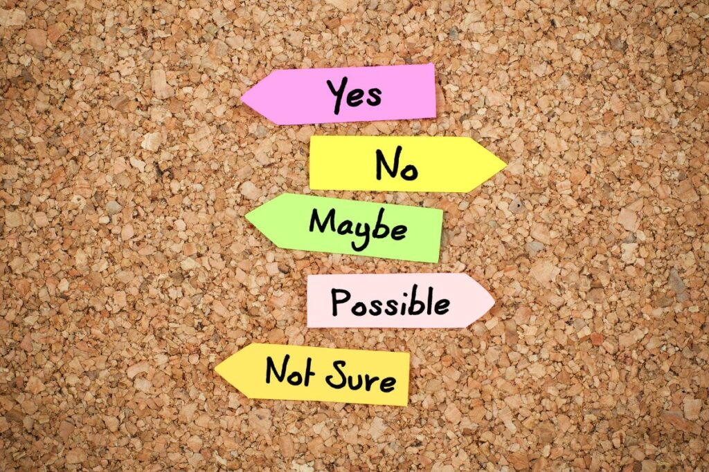 Colorful arrow signs pointing in different directions labeled yes, no, maybe, possible, and not sure
