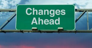 Green road sign reading “Changes Ahead” against a cloudy sky, representing a keystone habit